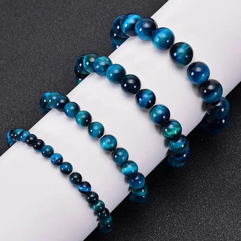Abyss Blue Tiger Eye bracelets in three bead sizes side by side