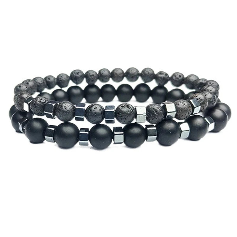 Lava stone and black onyx bead bracelets stacked on the wrist, close-up detail