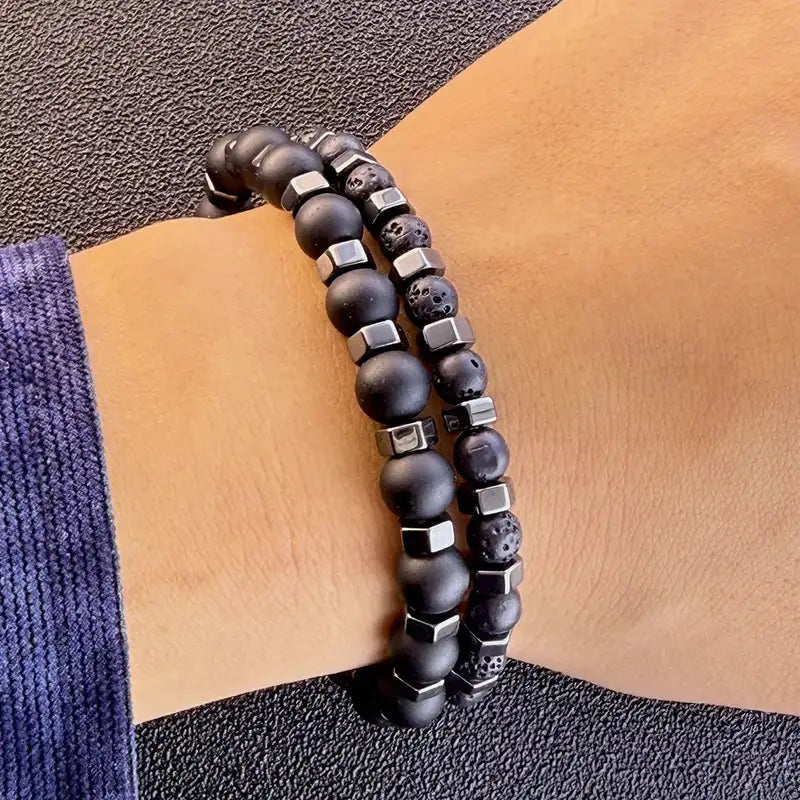 Two-piece lava and onyx bead bracelet set worn together on the wrist