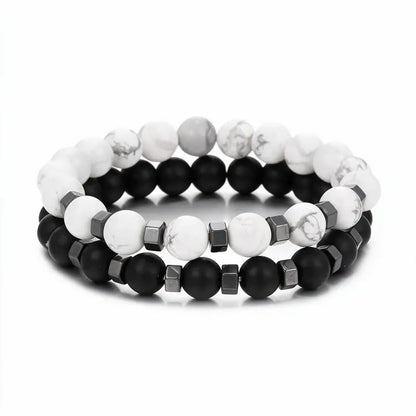 White howlite and matte black onyx bead bracelet set with hematite spacers, product photo on white background