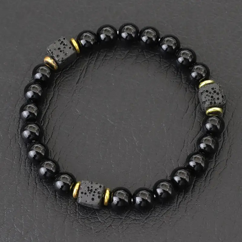 Glossy obsidian bead bracelet with gold spacer cubes