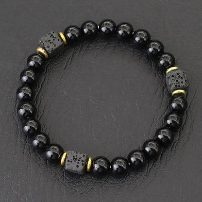 Glossy obsidian bead bracelet with gold spacer cubes