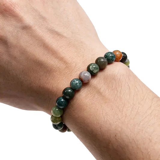 Multicolor Indian agate bead bracelet in shades of green, orange, and maroon, worn on a man's wrist.