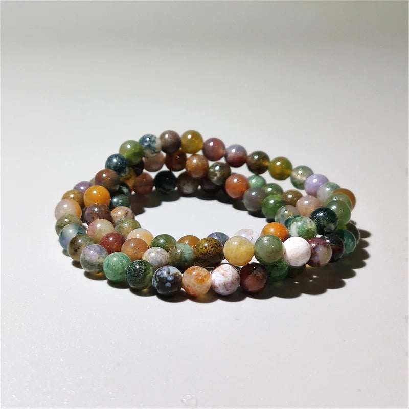 Three Indian agate bead bracelets laid out together showing color variation