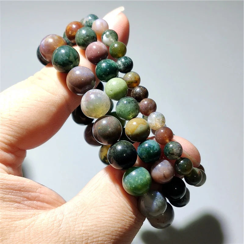 Indian agate bead bracelet held in hand, close-up of natural stone pattern