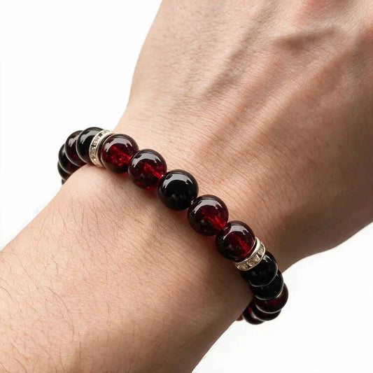 Haven Crackle Glass Bead Bracelet worn on wrist, deep red crackle glass and onyx beads with silver rhinestone spacers