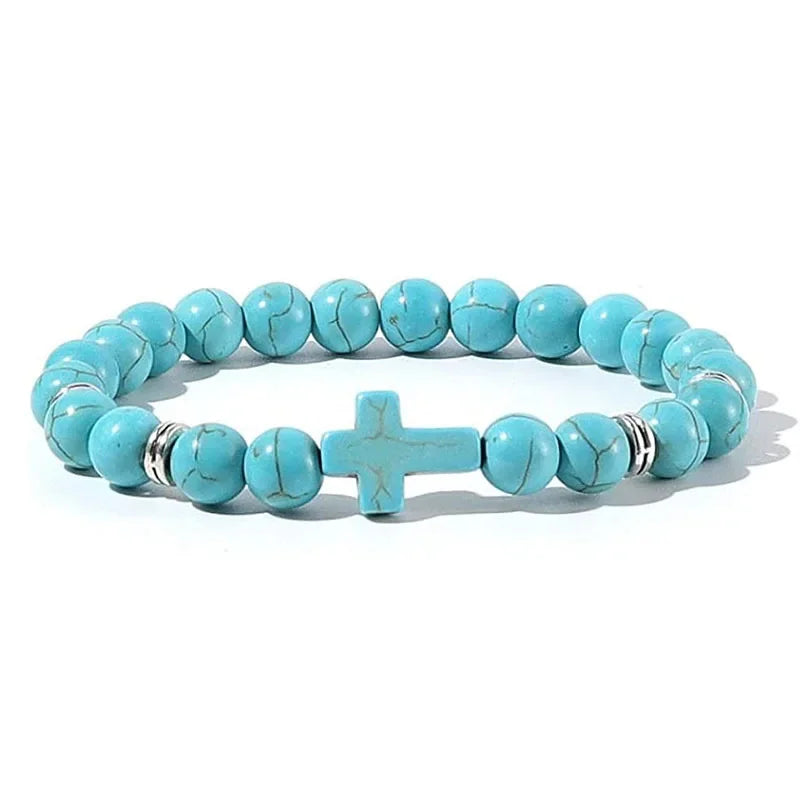 Turquoise bead bracelet with a matching turquoise cross bead and silver spacers