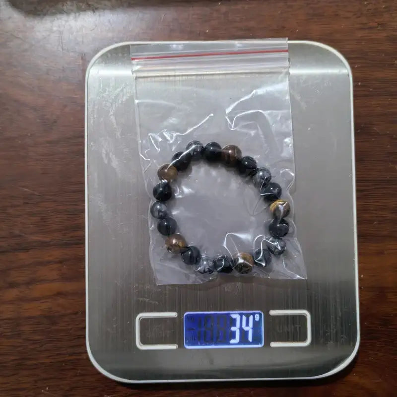 Tiger eye, black obsidian and hematite bead bracelet, angled studio shot