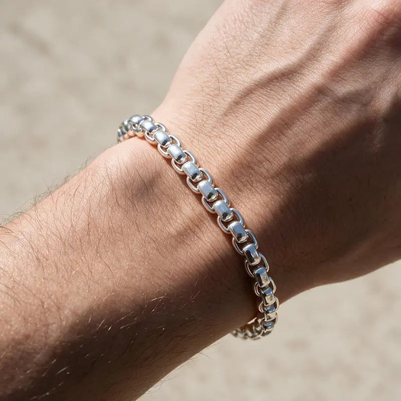 Silver smooth rounded box-link rolo chain bracelet worn on the wrist