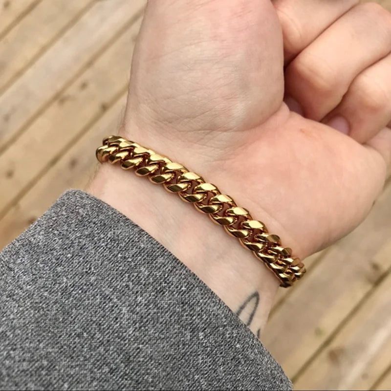 Gold Cuban link chain bracelet worn on the wrist