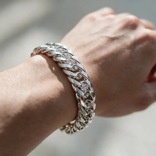 Thick silver double-row Cuban curb chain bracelet worn on the wrist