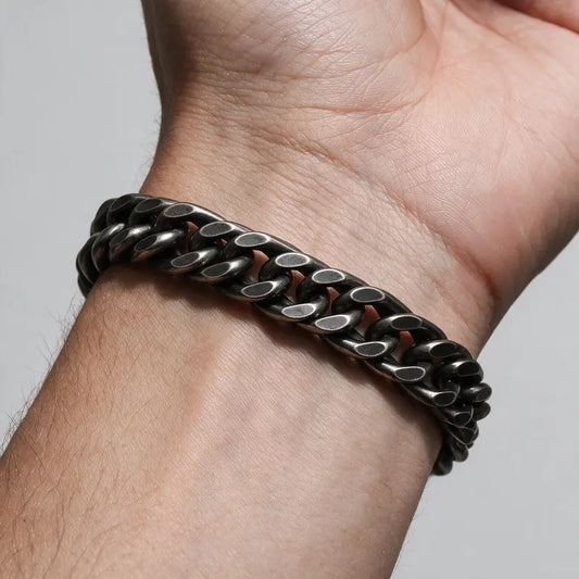 Colossus heavy oxidized Cuban double-curb link bracelet, worn on a man's wrist.