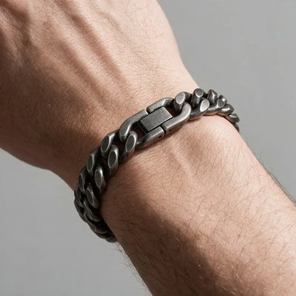 Drift oxidized gunmetal Cuban curb link bracelet, worn on a man's wrist.