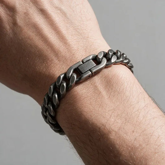 Drift oxidized gunmetal Cuban curb link bracelet, worn on a man's wrist.