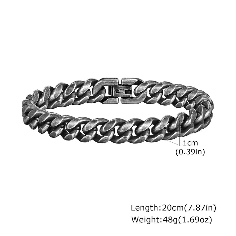 10mm oxidized gunmetal stainless steel Cuban curb link bracelet, 20cm, coiled flat on a white background