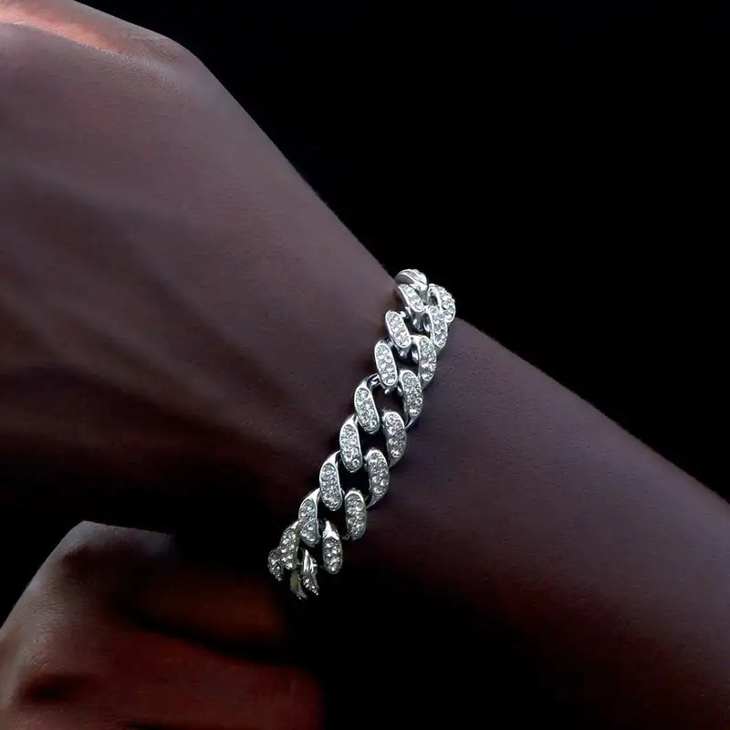 Silver iced-out Cuban link bracelet worn on the wrist