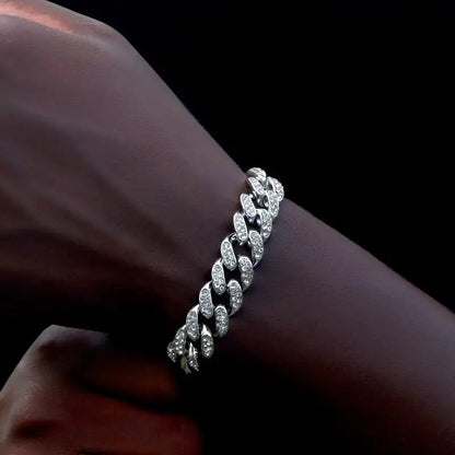 Silver iced-out Cuban link bracelet worn on the wrist