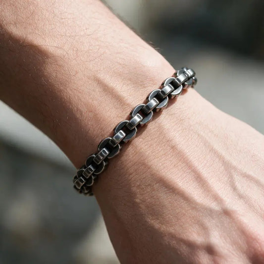 Dark oxidized stainless steel rolo box chain bracelet worn on the wrist