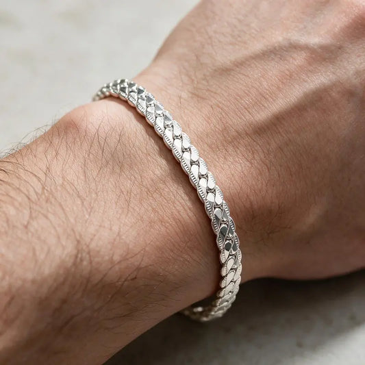 Silver scaled snake chain bracelet worn on the wrist