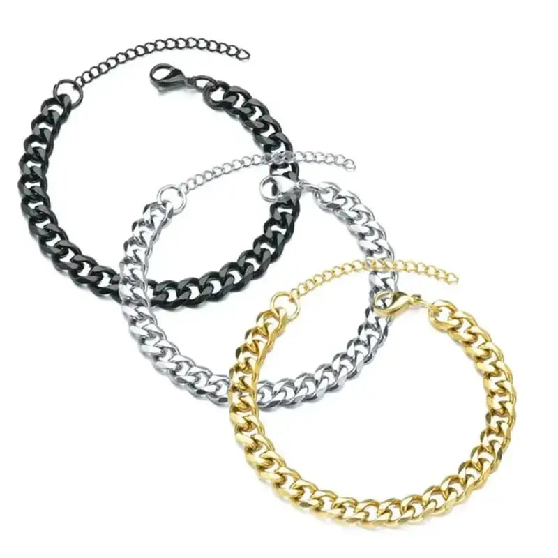 Gold, black and silver Cuban link chain bracelets shown together with lobster clasps and extension chains