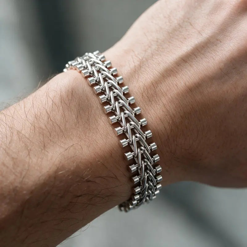 Silver riveted flat mesh chain bracelet worn on the wrist
