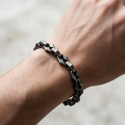 Dark oxidized stainless steel diamond-cut box chain bracelet worn on the wrist