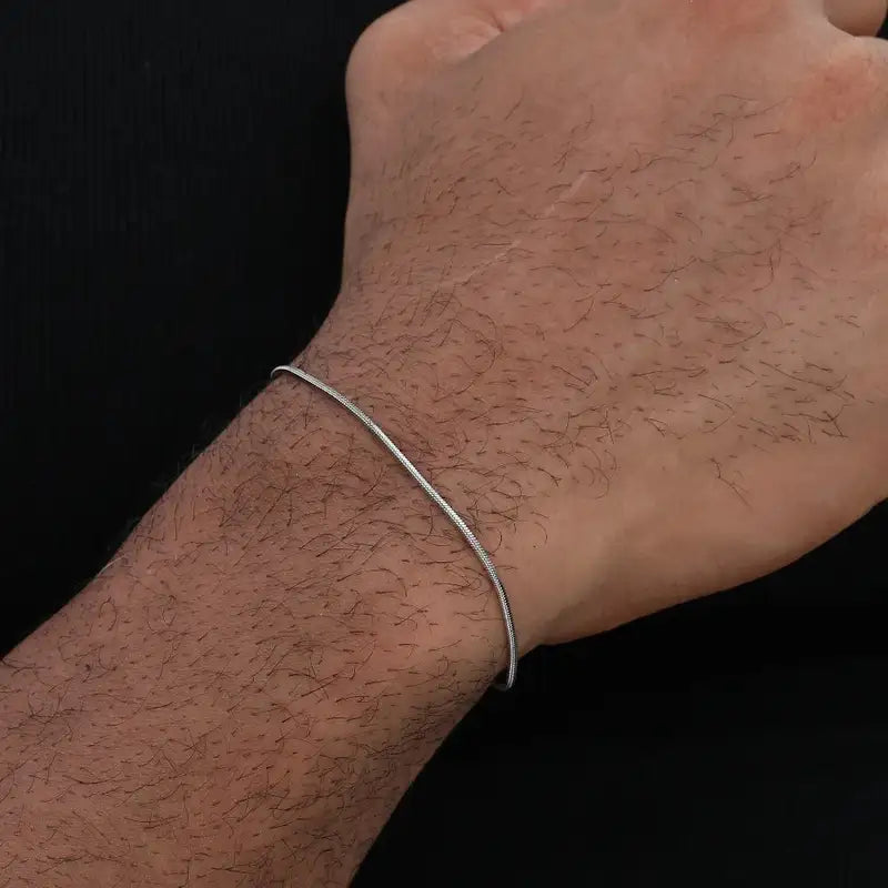 Silver snake chain bracelet worn on the back of the hand