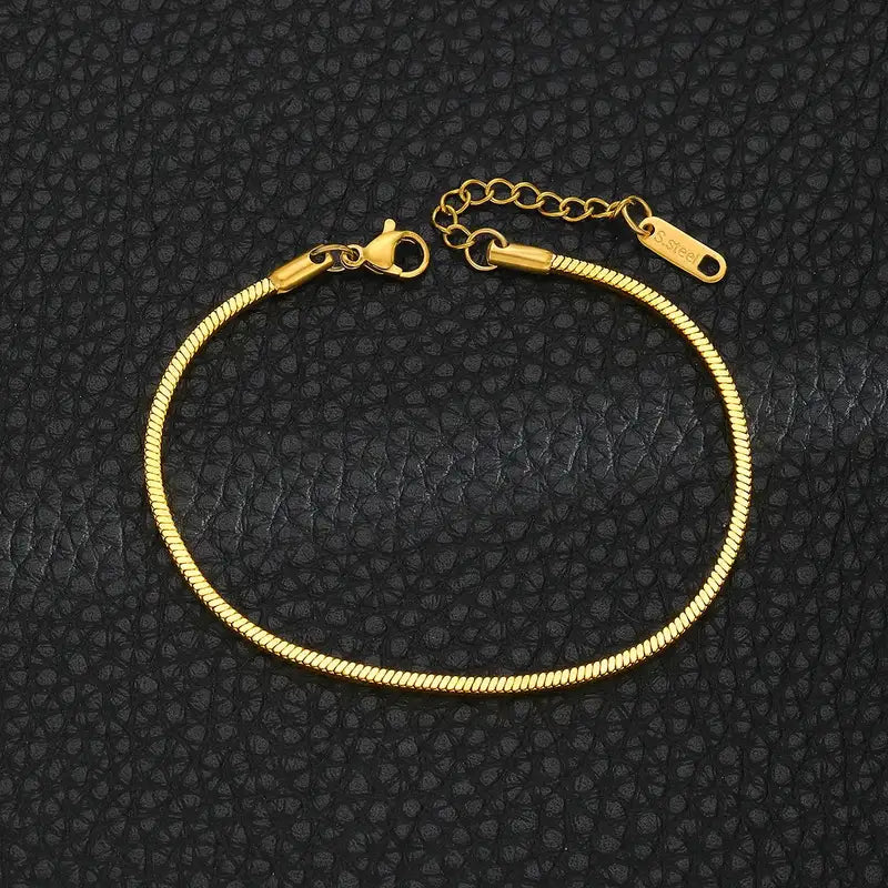 Gold snake chain bracelet laid flat, showing the lobster clasp and extension chain