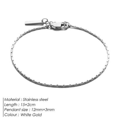 White gold-tone wire chain bracelet laid flat on a white background, labeled Stainless steel, 15+2cm length, 12mm×3mm pendant size, White Gold colour.