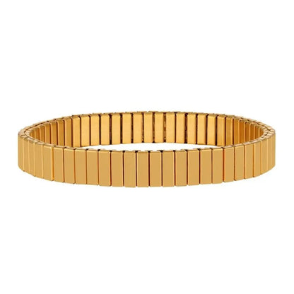Gold flexible stretch bracelet with rectangular link segments, standing upright on a plain white background