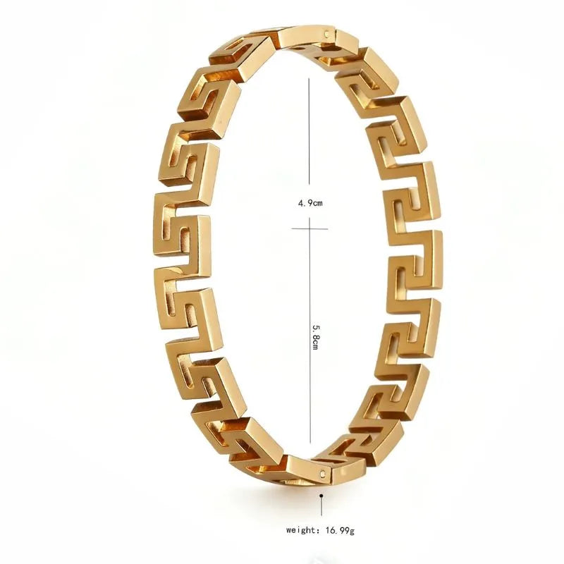 Gold Greek key link bangle bracelet shown at an angle with diameter measurements (4.9cm by 5.8cm) and weight (16.99g) labelled