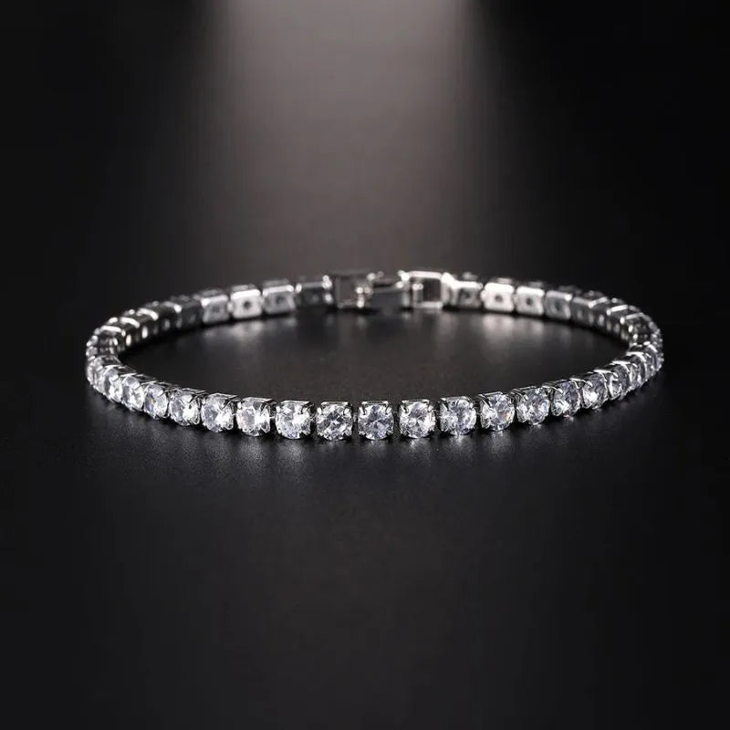 Silver tennis bracelet with clear cubic zirconia stones under a dramatic spotlight on a black background