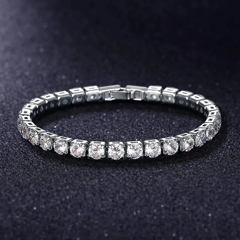 Silver tennis bracelet with clear cubic zirconia stones on a textured dark surface