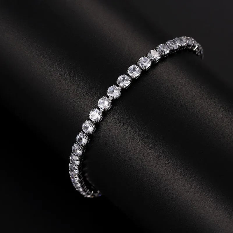 Luxury iced-out gold tennis bracelet crafted with brilliant cubic zirconia and a comfortable fold-over clasp.