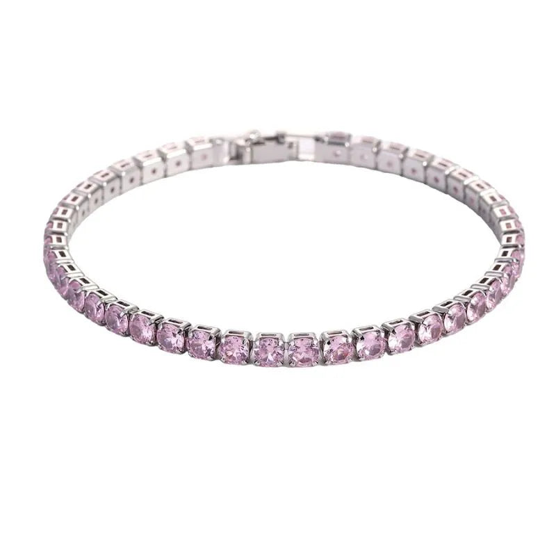 Tennis bracelet with pink stones in a silver setting, on a plain white background