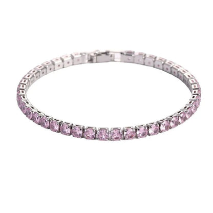 Tennis bracelet with pink stones in a silver setting, on a plain white background