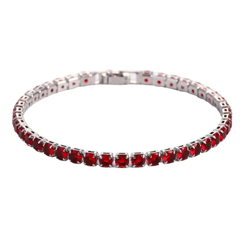 Tennis bracelet with red ruby-coloured stones in a silver setting, on a plain white background