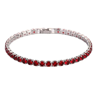 Tennis bracelet with red ruby-coloured stones in a silver setting, on a plain white background