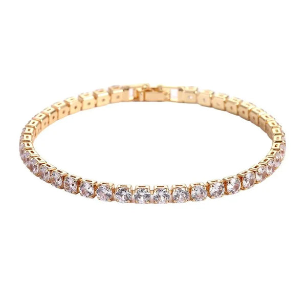 Gold tennis bracelet with round clear cubic zirconia stones in prong settings, on a plain white background