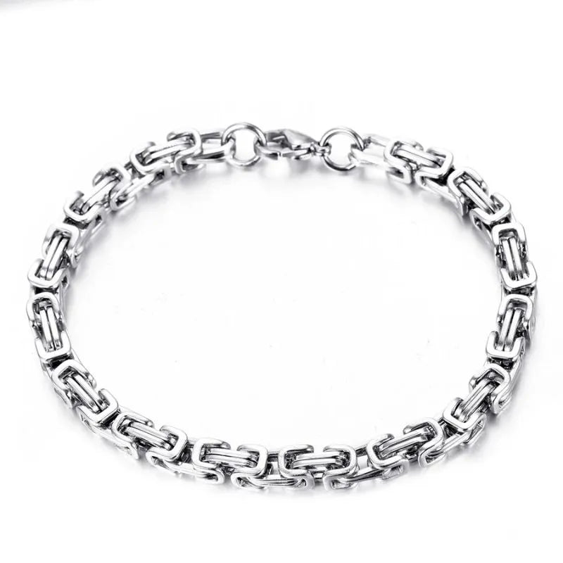 Silver-tone Byzantine box-chain bracelet laid flat in a circle on a plain white background.