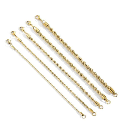 Multiple gold twisted rope chain bracelets of increasing width laid diagonally on a white background.
