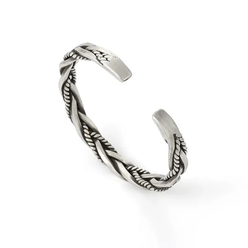 Silver open-cuff twisted bracelet shown from a side angle on a plain white background.