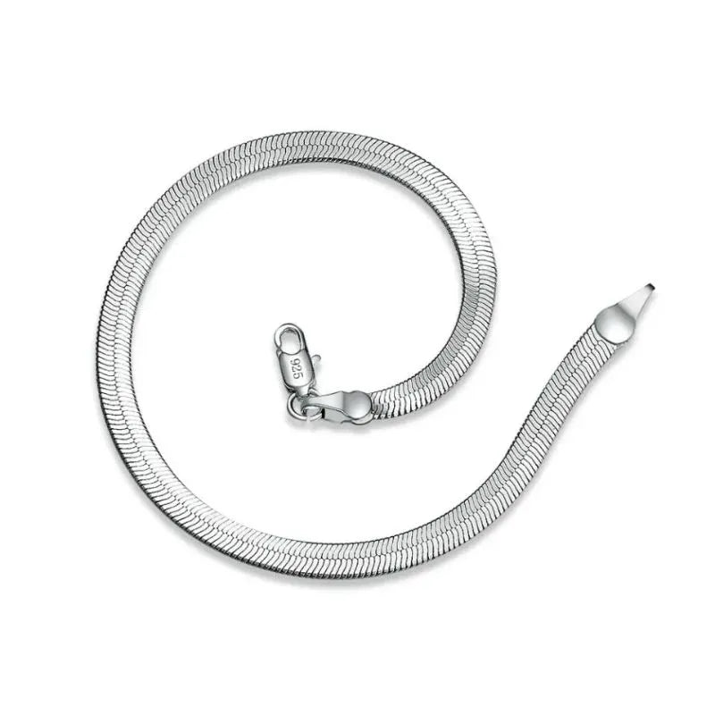 Silver flat blade chain bracelet coiled loosely on a white background, with a '925' stamp visible on the clasp.