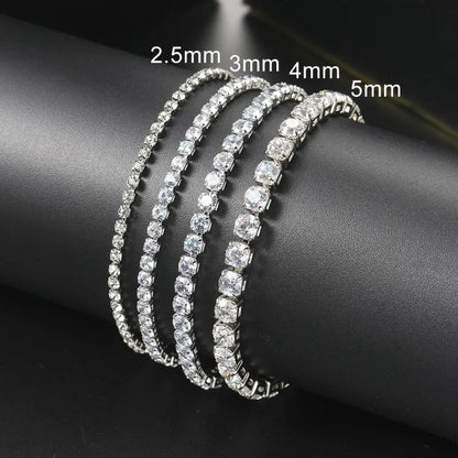 Four silver tennis bracelets in increasing stone sizes — 2.5mm, 3mm, 4mm, and 5mm — draped around a black display stand.