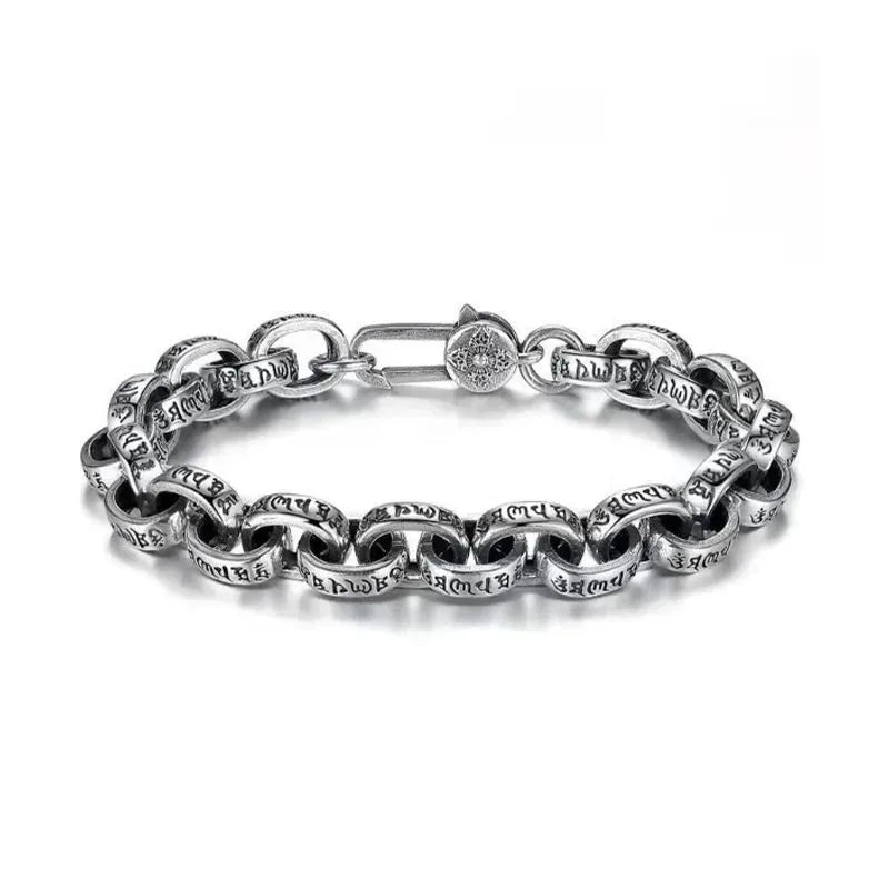 Silver oval-link chain bracelet with engraved Tibetan mantra script, laid in an oval on a plain white background, showing the round decorative clasp.