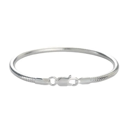 Silver snake chain bracelet laid flat in an oval on a plain white background.
