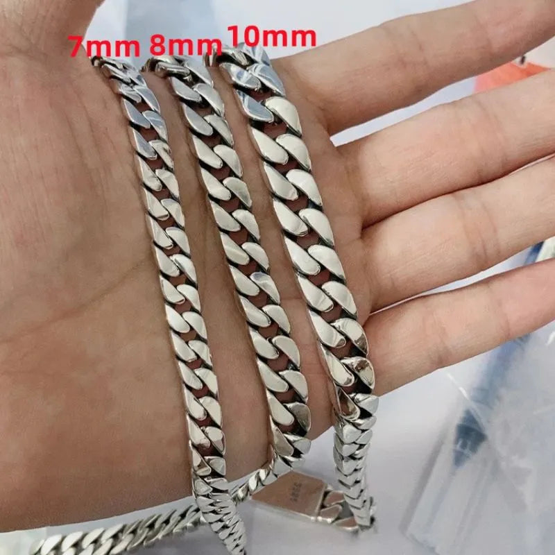 Three silver Cuban chains in 7mm, 8mm, and 10mm widths held flat across an open palm, labeled in red text.