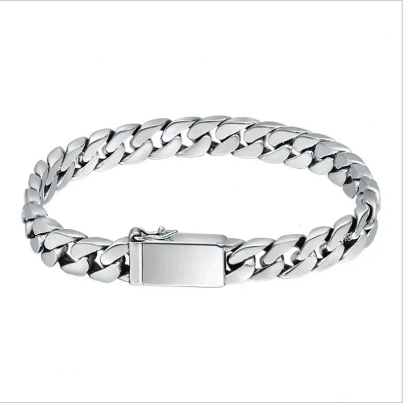 Silver Cuban-link bracelet laid in an oval on a plain white background.