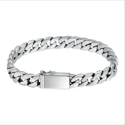 Silver Cuban-link bracelet laid in an oval on a plain white background.