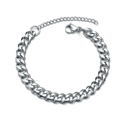Silver Cuban chain bracelet laid in a circle on a plain white background, with the lobster clasp and extension chain visible.